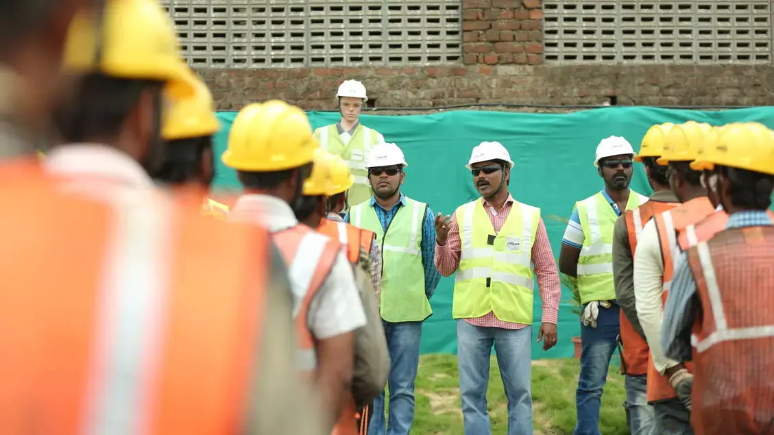 Employees at daily site meeting
