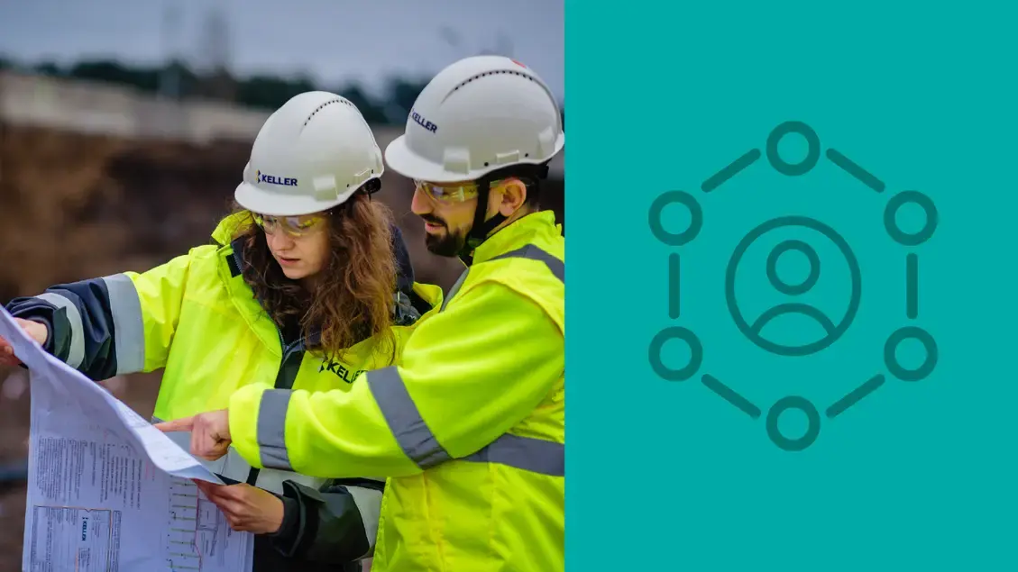 Two employees on site consulting a site plan