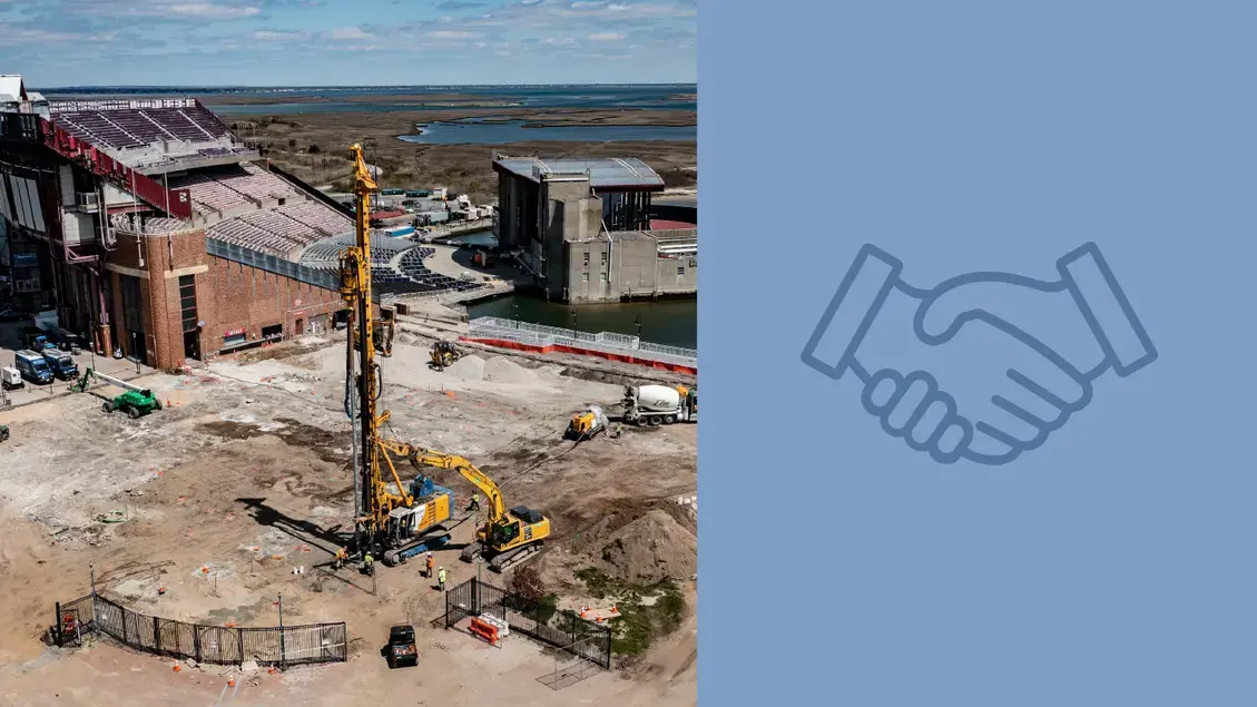 Aerial view with a rig in action on site with a baseball stadium in the background