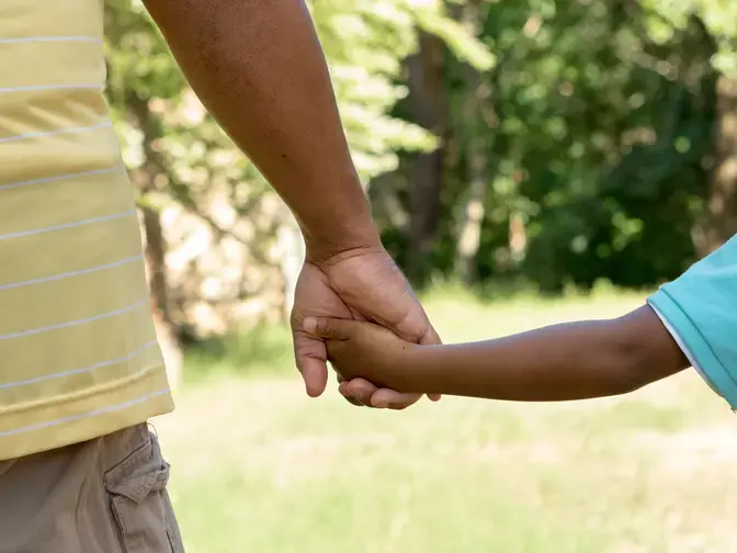 father and son holding hands