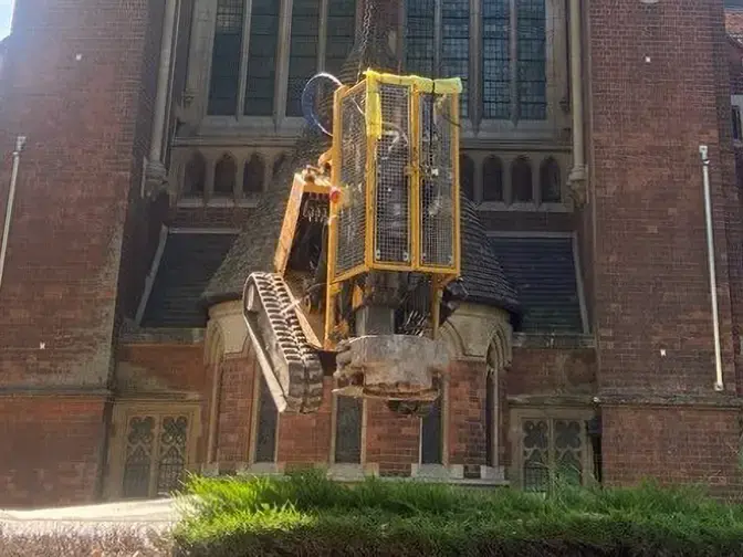 A rig being lowered into the grounds of the Catholic Apostle Church