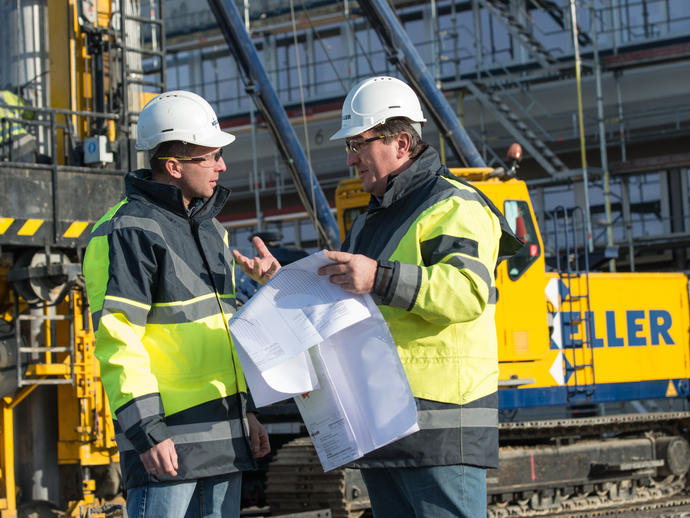 Employees on site discussing project