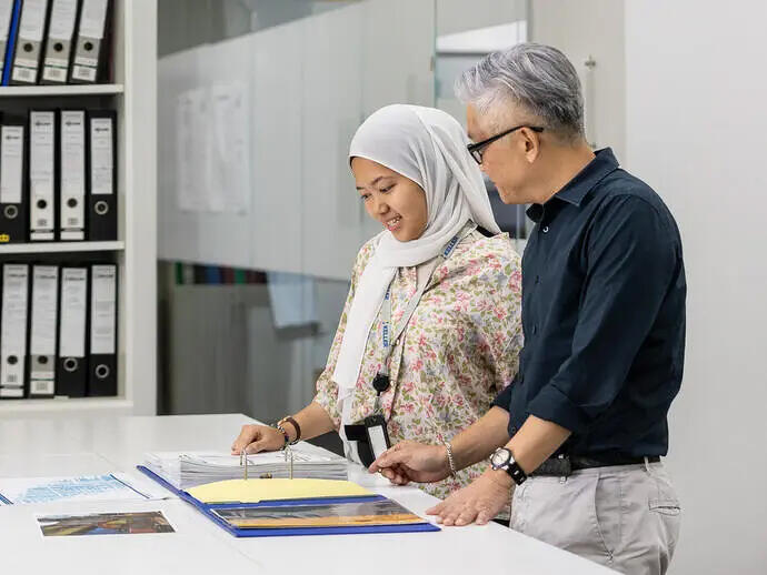 People looking through documents